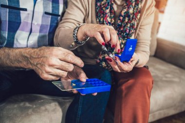 Yaşlı kişi ilaç alarak, yakın