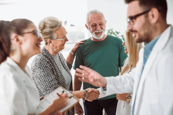 Group of young doctor during home visit senior people — Stock Photo, Image