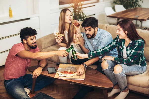 Group of young friends eating pizza.Home party.Fast food concept.