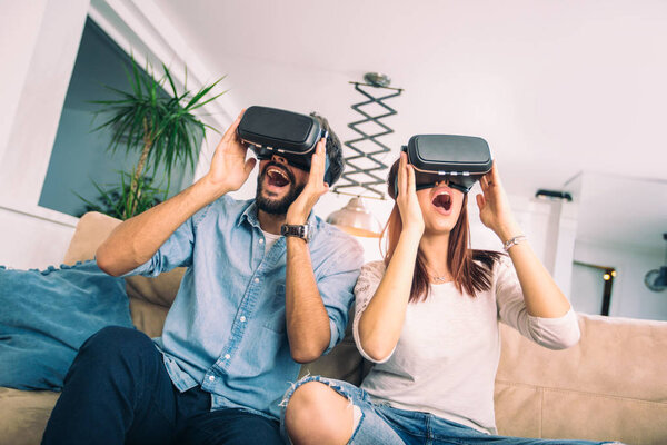 Young man and woman in casual clothes wear the virtual reality glasses are watching and showing imagine via the VR camera, Technology and innovation concept