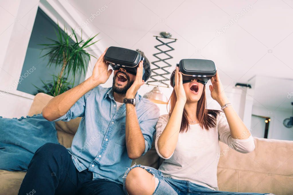 Young man and woman in casual clothes wear the virtual reality glasses are watching and showing imagine via the VR camera, Technology and innovation concept