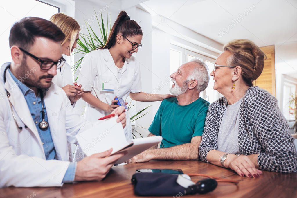 Senior Couple In Discussion With Health Visitor At Home. They talk about prescribed therapy