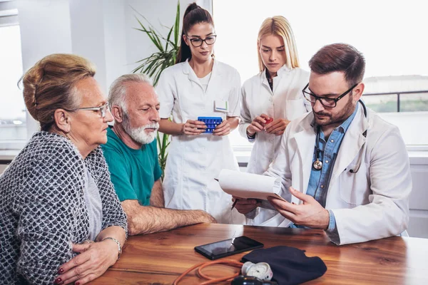 Senior Couple In Discussion With Health Visitor At Home. They talk about prescribed therapy