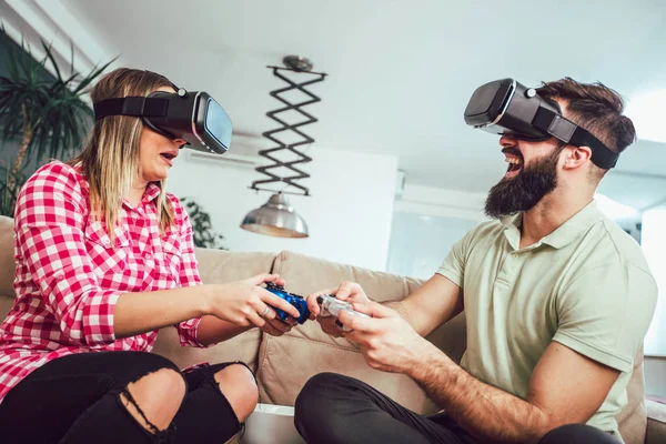 Happy friends playing video games with virtual reality glasses - Young people having fun with new technology console online