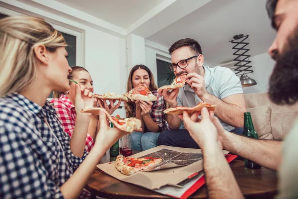 Group of young friends eating pizza.Home party.Fast food concept.