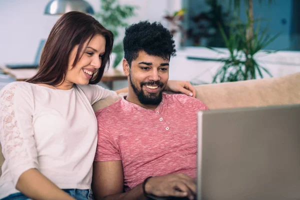 couple with laptop spending time together at home