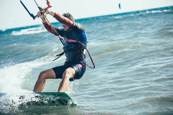 View of man riding on kiteboard in wavy sea