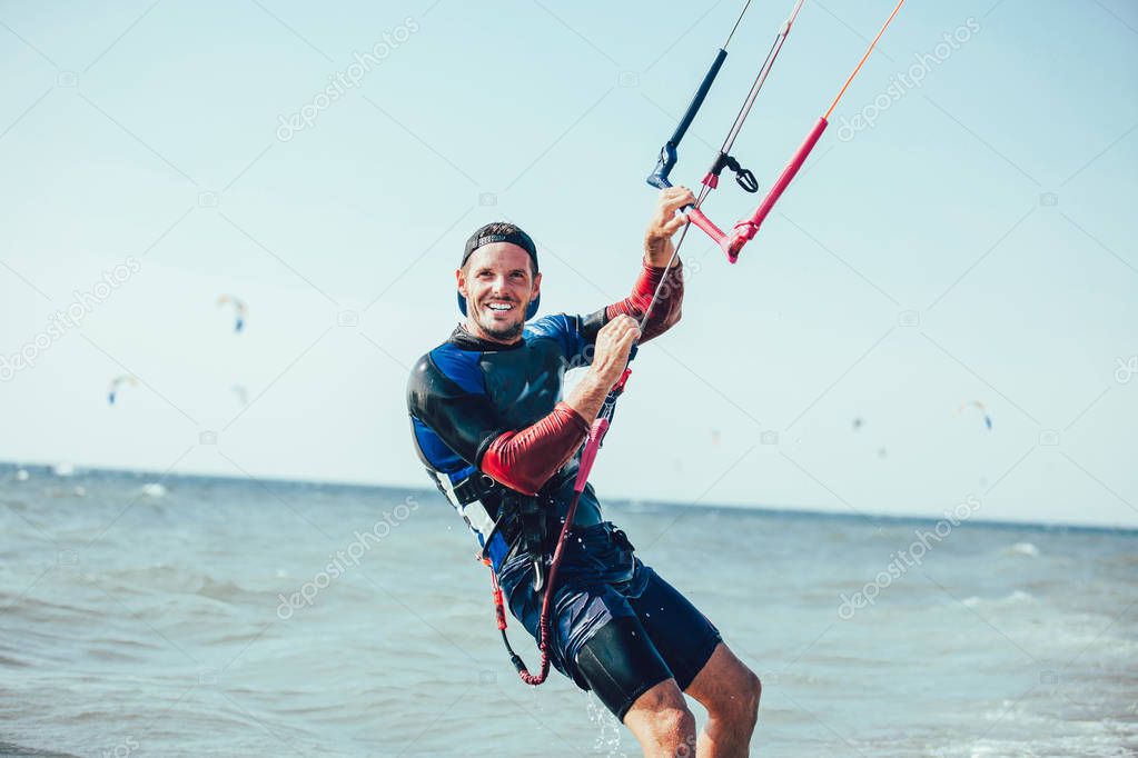View of man riding on kiteboard in wavy sea
