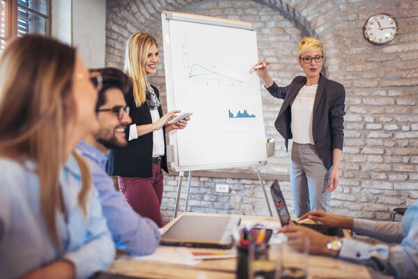 Business colleagues in conference meeting room during presentation