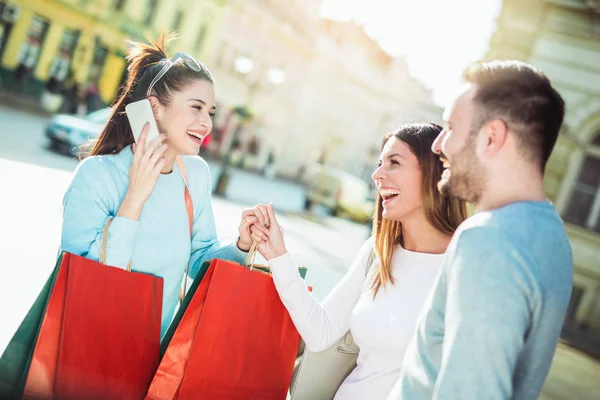 Happy friends shopping. Young friends enjoying shopping in the city.