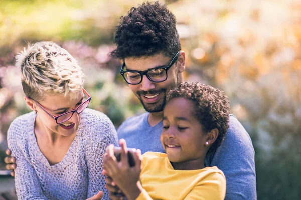 Happy Young Mixed Race Couple Spending Time Daughter Using Smart — Stock Photo, Image