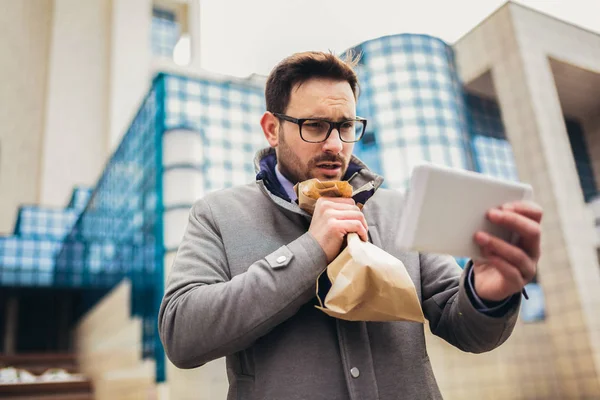 Businessman holding paper bag over mouth as if having a panic at — Stock Photo, Image