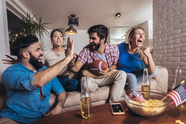 Group of friends sport fans watching rugby match