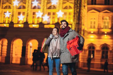 Backgr tatil parlakları ile şehir merkezinde genç çift