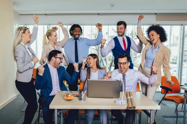 Happy business people celebrating success at company — Stock Photo, Image