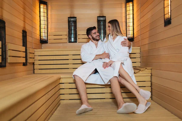 People in bathrobes using sauna at spa resort — Stock Photo, Image
