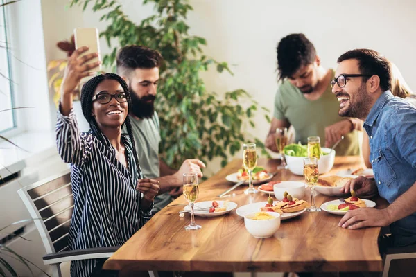 Abendessen mit Freunden. Gruppe fröhlicher junger Leute — Stockfoto