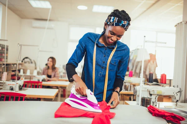 Tailor ironing in the modern sewing workshop. — Stock Photo, Image