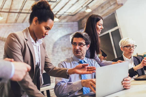 Sorridente giovane manager aiutare il lavoratore anziano con il lavoro al computer i — Foto Stock