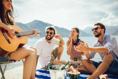 Mutlu gençler plaj partisinde eğleniyor..