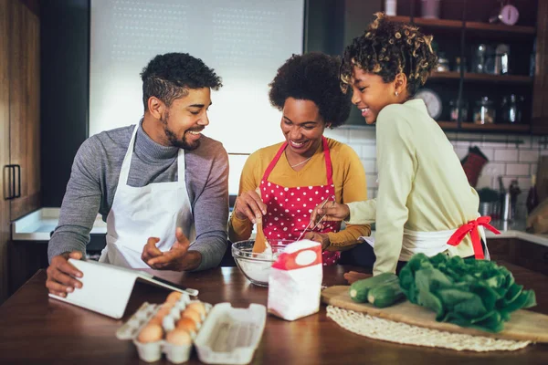 Happy black family spending day at kitchen.