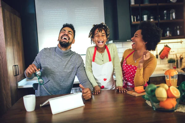 Счастливая черная семья проводит день на кухне с помощью цифрового планшета — стоковое фото