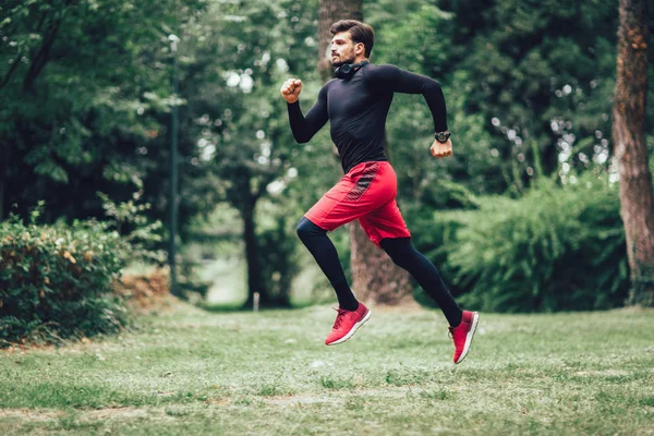 Joven corriendo en el parque durante la mañana — Foto de Stock