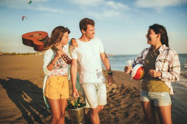 Genç arkadaşlar güneşli bir günde kumsalda yürüyüş yapıyorlar ve...