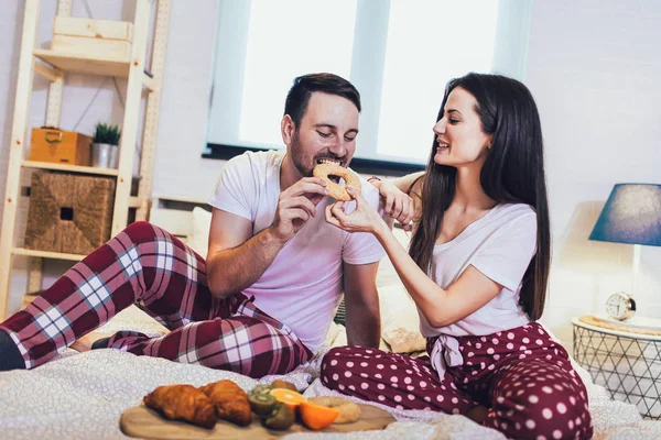 Romantik mutlu çift yatakta kahvaltı yapıyor.