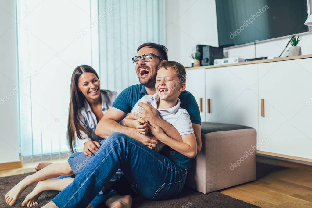 Family time.Mother,father and son having fun at home.