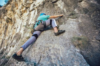 Kayaya tırmanan yaşlı bir adam..