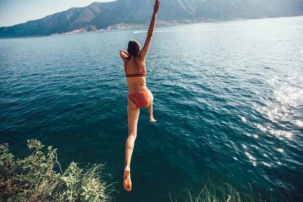 Jonge Vrouw Springen Van Een Rots Zee — Stockfoto