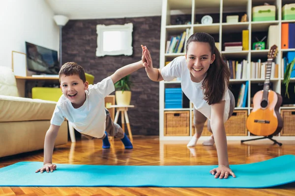 stock image Children exercising at home. Family working out at home.