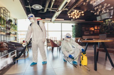 Professional workers in hazmat suits disinfecting indoor of cafe or restaurant, pandemic health risk, coronavirus clipart