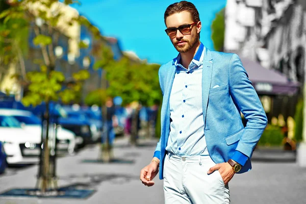 High fashion look.Young stylish confident happy handsome businessman model in suit clothes walking in the street in sunglasses — Stock Photo, Image