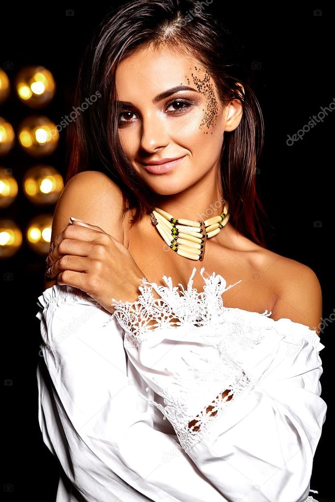 Beautiful girl model in summer white dress with bright creative makeup on black studio lights background