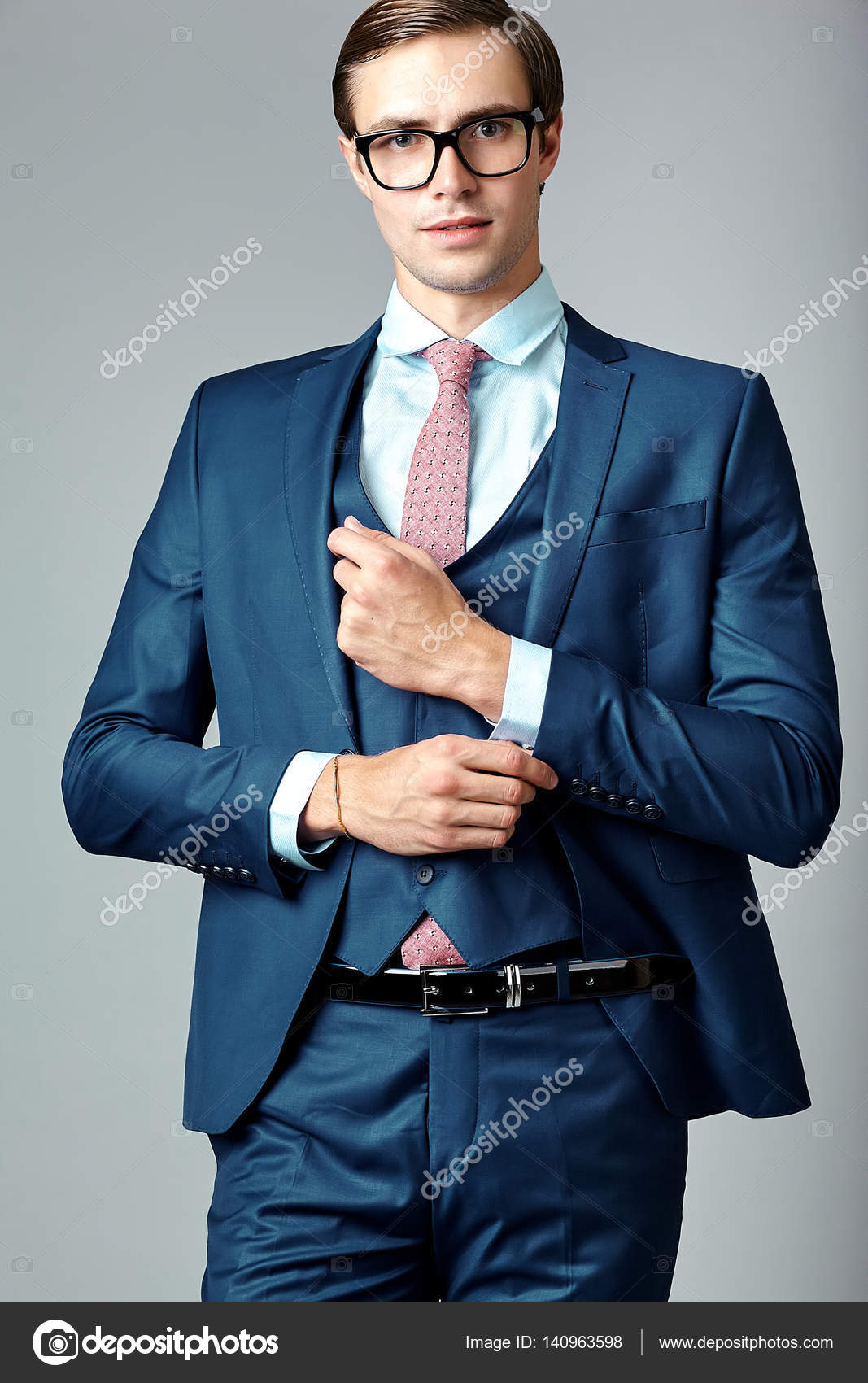 Handsome male model posing wearing a blue suit. Stock Photo | Adobe Stock