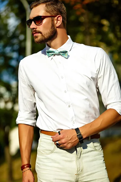 Handsome hipster model man in stylish summer clothes