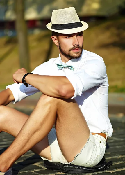 Handsome hipster model man in stylish summer clothes