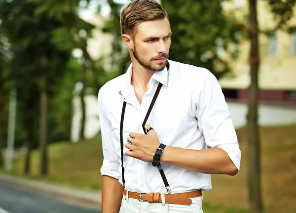 Handsome hipster model man in stylish summer clothes