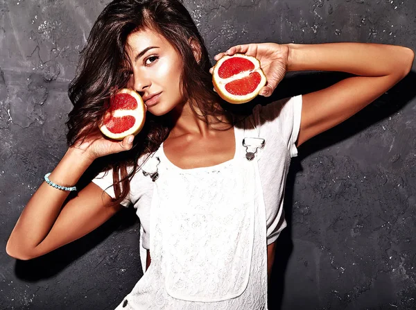Model in casual white summer clothes with fresh sliced red grapefruit — Stock Photo, Image