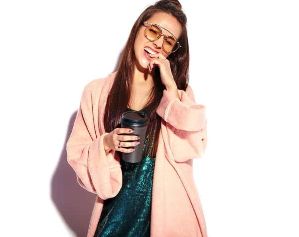Bonito modelo de mulher morena hipster sorridente em casaco rosa elegante e vestido de noite azul isolado no fundo branco — Fotografia de Stock