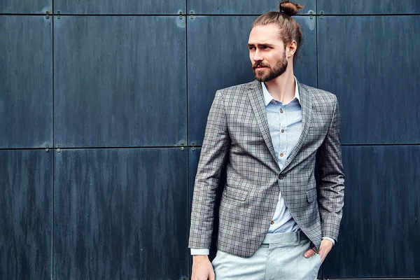 Portrait of sexy handsome fashion male model man dressed in elegant checkered suit posing outdoors on the street background — Stock Photo, Image