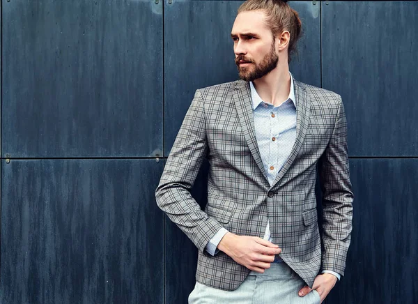 Portrait of sexy handsome fashion male model man dressed in elegant checkered suit posing outdoors on the street background — Stock Photo, Image