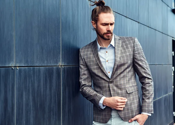 Portrait of sexy handsome fashion male model man dressed in elegant checkered suit posing outdoors on the street background — Stock Photo, Image