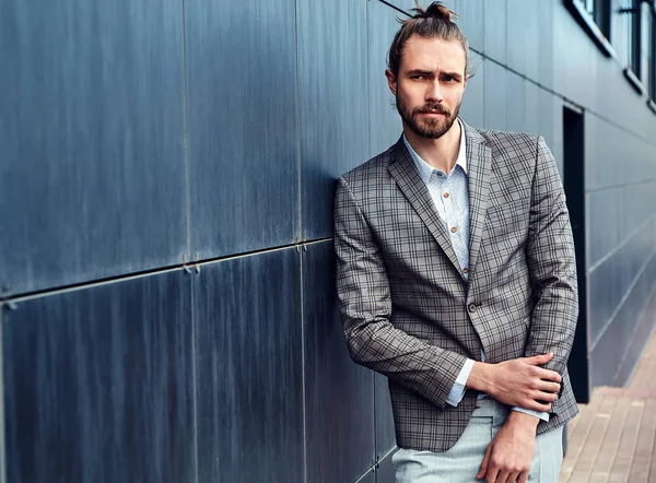 Portrait of sexy handsome fashion male model man dressed in elegant checkered suit posing outdoors on the street background — Stock Photo, Image