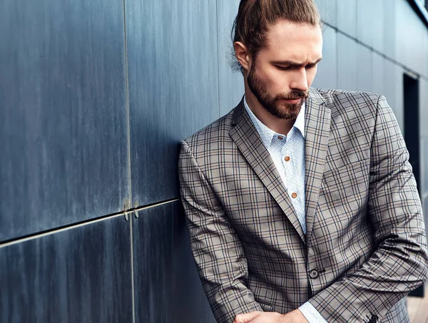 Portrait of sexy handsome fashion male model man dressed in elegant checkered suit posing outdoors on the street background — Stock Photo, Image