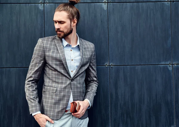 Portrait of sexy handsome fashion male model man dressed in elegant checkered suit posing outdoors on the street background — Stock Photo, Image