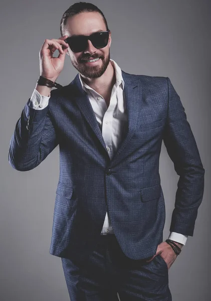 Handsome fashion stylish hipster businessman model dressed in elegant blue suit — Stock Photo, Image