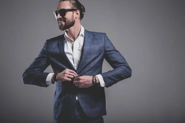 Handsome fashion stylish hipster businessman model dressed in elegant blue suit — Stock Photo, Image